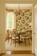 Botanica wallpaper with floral pattern on the walls of a dining room.