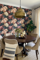 Nocturne Peonia wallpaper with a large floral pattern, featuring blossoms in shades of pink and cream, set against a dark background.