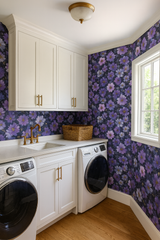 Floral pattern wallpaper on a laundry room wall, no brand attribution, featuring purple flowers on a dark background.
