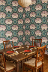 Floral pattern wallpaper with a lotus flower design on a teal background.
