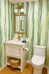Green and white Whispering Blades Wallpaper with a watercolor pattern on the bathroom walls.