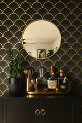 Black and gold art deco wallpaper by Wallshoppe, featuring a scallop or fan pattern that evokes a retro, elegant style.
