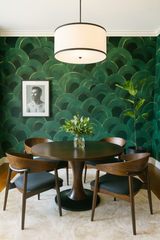 Green wallpaper with gold accents and scalloped pattern, verdant echoes on the wall.
