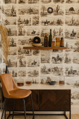 Sonoran Vignette wallpaper with a Western-style pattern of cowboys, cacti, and landscape scenes.
