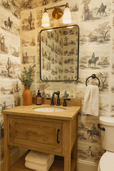 Western toile wallpaper with cowboys and cacti, featuring a sepia color palette.
