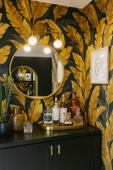 Golden Tropic wallpaper with gold leaf pattern on black background.