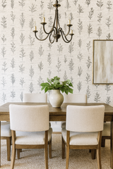 Botanical scroll wallpaper with leaf pattern and hand-written script, displayed with a wood dining set.
