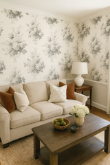 Floral sepia bloom wallpaper with vintage roses and botanical accents, covering the walls of a living room.