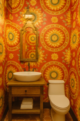 Floral wallpaper with sunflower pattern on orange background.