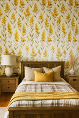 Goldenrod Whimsy Wallpaper with a floral pattern, covering the wall behind a wooden bed.