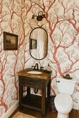Manzanita tangle wallpaper with orange tree pattern, covering the bathroom walls.