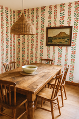 Berry Bright Boulevard Wallpaper with red berries and green leaves on a cream-colored background.
