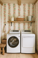 Berry patterned wallpaper with red berries and green leaves, in a vertical stripe arrangement.
