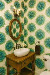 Succulent geometry wallpaper with green and turquoise floral pattern, covering bathroom walls.

