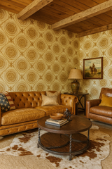 Gilded Medallion Reign wallpaper with circle pattern on the walls of a traditionally decorated living room.
