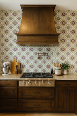 Stitch & Rosette Revival Wallpaper with a purple floral pattern filling a kitchen backsplash behind the stove.