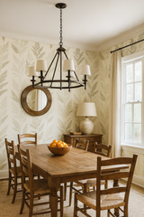 Fern-patterned wallpaper in cream and green, with a fern leaf design, covering the dining room walls.