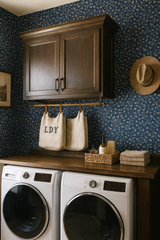 Inkwash Brambletrail Wallpaper with floral pattern, set in a laundry room with dark wood cabinets and white appliances.
