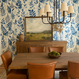 Botanical Blueprint Wallpaper with a blue leaf pattern covering the wall.
