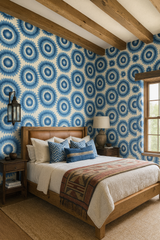 Blue sunburst wallpaper with a floral-inspired pattern, covering a bedroom wall.
