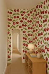 Cherry Bombshell Wallpaper with a repeating cherry pattern on an off-white background.
