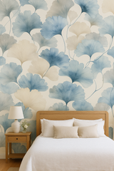 Mistleaf Whisper Wallpaper with blue and beige leaves, styled in a bedroom setting.
