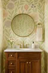 Pomegranate Parade Wallpaper with pastel floral and fruit pattern on a light yellow background.