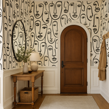 Lineage wallpaper in black and white with abstract face pattern, shown on a wall.