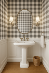 Gray and white check wallpaper with buffalo plaid pattern, next to a white sink and vanity.