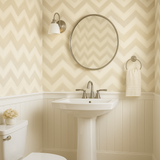 Sand whisper wallpaper with chevron pattern, styled in a bathroom with sink and mirror.
