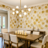 Sunspore Bloom Wallpaper with a golden botanical print, featuring white decorative trim and a modern chandelier.
