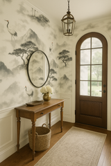 Zen Summit wallpaper with misty mountains and crane pattern, set in a decorative hallway.