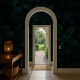 Dark leaf wallpaper with botanical pattern, behind an arched doorway with a garden view.
