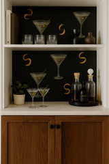 Dirty Martini wallpaper with a black background, martini glass illustrations, and gold crescents.
