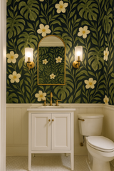 Monstera Noire wallpaper with a tropical foliage pattern, featuring leaves and flowers, against a dark background.
