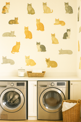 Cat's Meow wallpaper with playful cat illustrations, displayed in a laundry room setting.