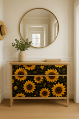 Midnight Sunflowers wallpaper with a dark floral pattern, showcasing a dresser covered in the bold print.
