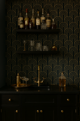 Deco Dawn Wallpaper featuring a bold geometric art deco pattern in gold against a dark teal background.
