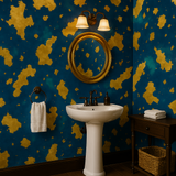 Gilded Archipelago Wallpaper with an archipelago pattern, set in a bathroom with a pedestal sink.
