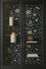 Chinoiserie midnight wallpaper with floral and bird pattern on a cabinet backdrop.
