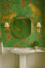 Jungle Fables Wallpaper with green floral and animal print by unknown designer, visible in bathroom setting with vanity.