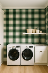Green plaid wallpaper with bold tartan pattern, featuring baskets and jars on a white shelf.