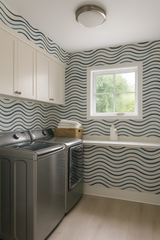 Tidal Lines Wallpaper with blue wave pattern, installed in a laundry room setting.