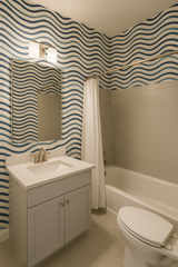 Tidal Lines Wallpaper with blue wave pattern, covering bathroom walls in a repeating design.