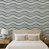 Tidal Lines wallpaper with wavy blue design on beige background.