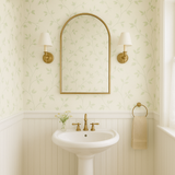 Leafy green Ivy Dreams Wallpaper with a pale yellow background, patterned with climbing vines.
