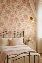 Bloomfield wallpaper with rose floral pattern on a bedroom wall behind a bed, bedside table, and curtains.
