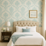 Vintage damask wallpaper with light blue floral pattern on a cream-colored backdrop.