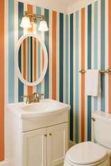 Cabana Revival Wallpaper with colorful stripes, including orange, blue, and cream tones.
