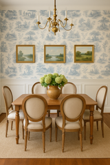 Toile de Jouy wallpaper with a blue pastoral scene, adorning the upper portion of a dining room.
